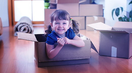Girl smiling in her new apartment, thanks to FAB Mortgage Loans for Small Buildings
