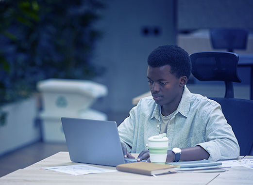 Businessman with laptop, showcasing the UAE as a top destination for entrepreneurs.